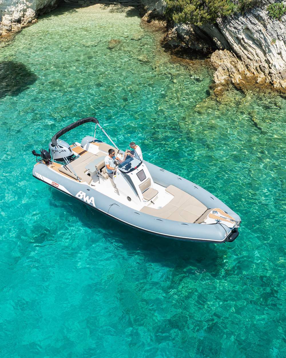 RIB boat at anchor in a turquoise cove in Lefkada