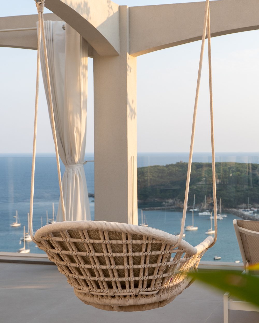 Hanging chair overlooking the marina at a Lefkada villa
